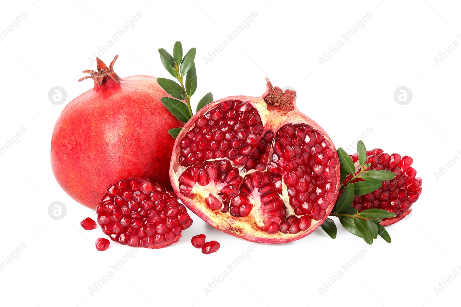 Photo of Fresh pomegranates and branches isolated on white