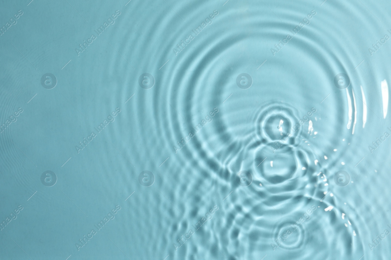 Photo of Closeup view of water with circles on turquoise background