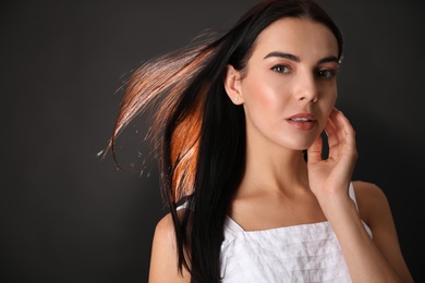 Portrait of beautiful young woman on black background