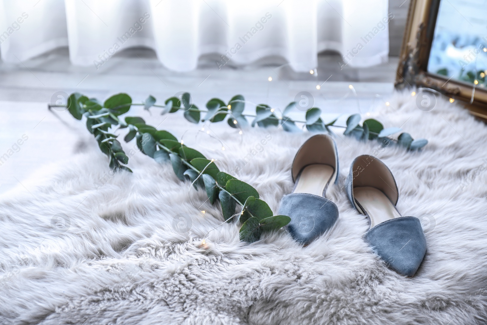 Photo of Elegant female shoes on fluffy carpet