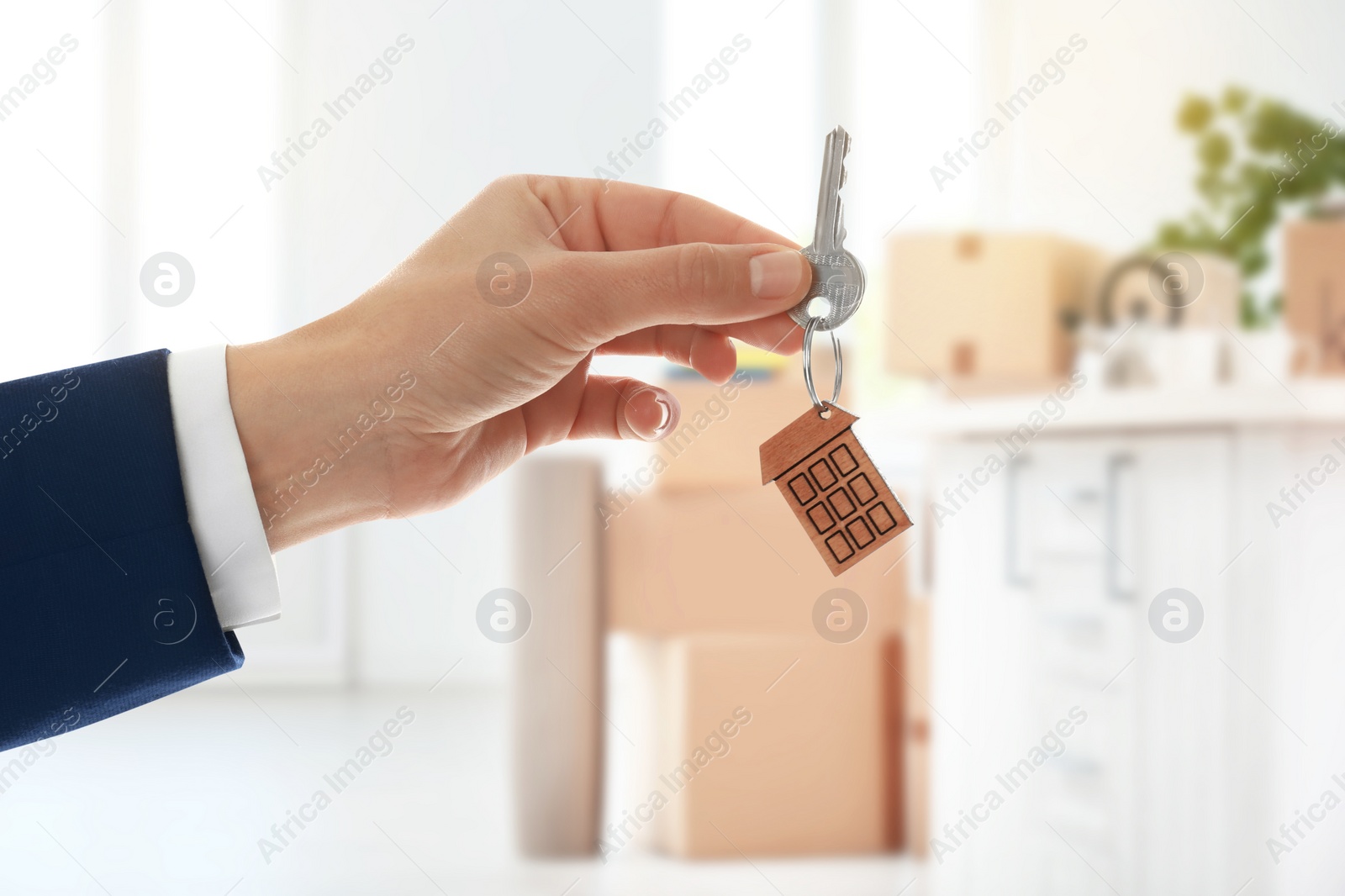 Image of Man with key in new modern apartment, closeup