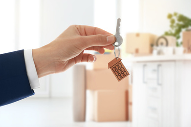 Image of Man with key in new modern apartment, closeup