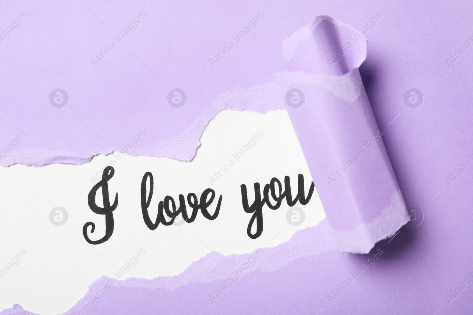 Photo of Text I Love You on white background, view through torn purple paper