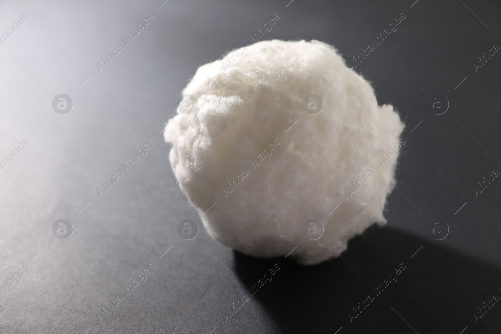 Photo of Ball of clean cotton wool on grey background, closeup