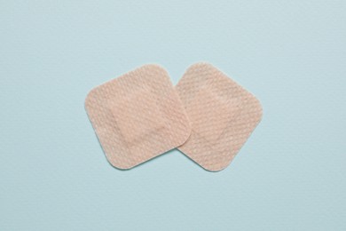 Contraceptive patches on light blue background, flat lay