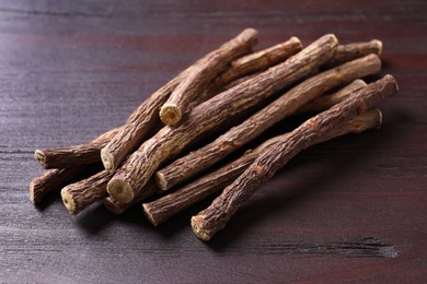 Dried sticks of liquorice root on wooden table