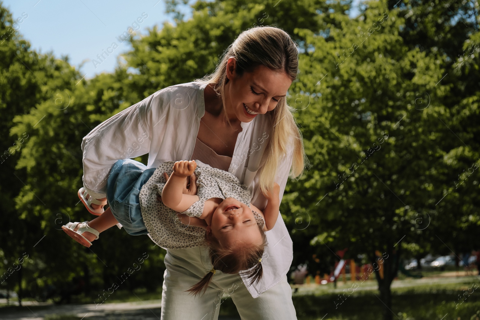 Photo of Happy mother with her daughter having fun in park