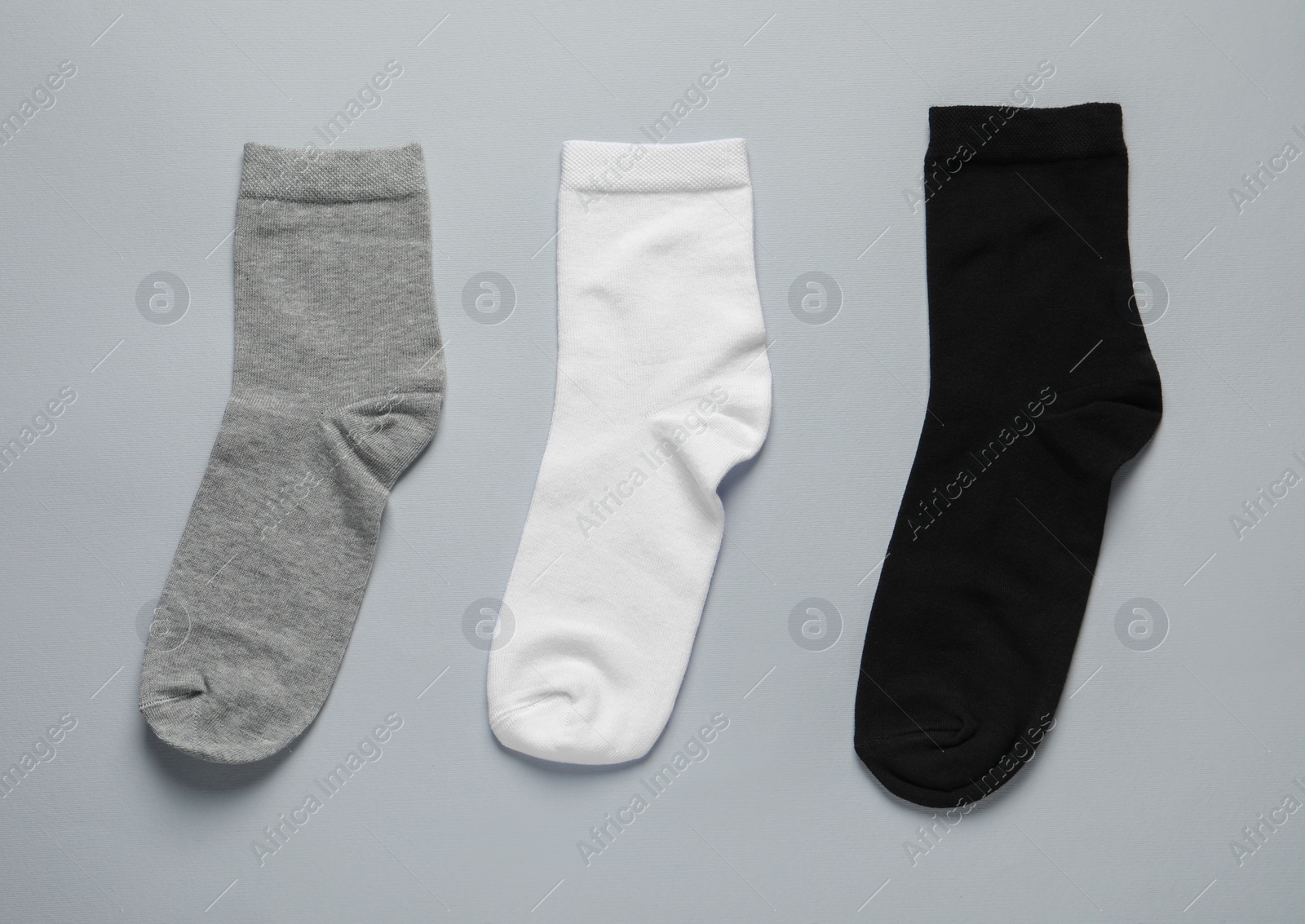 Photo of Different socks on light grey background, flat lay