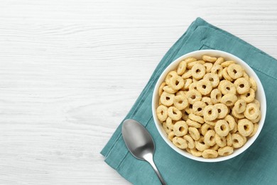 Photo of Bowl of sweet crispy corn rings on white wooden table, flat lay with space for text. Breakfast cereal