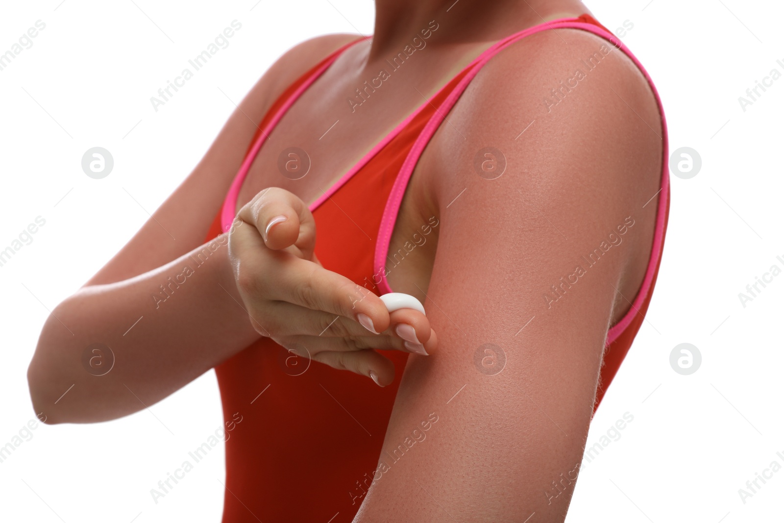 Photo of Woman applying cream on sunburn against white background, closeup