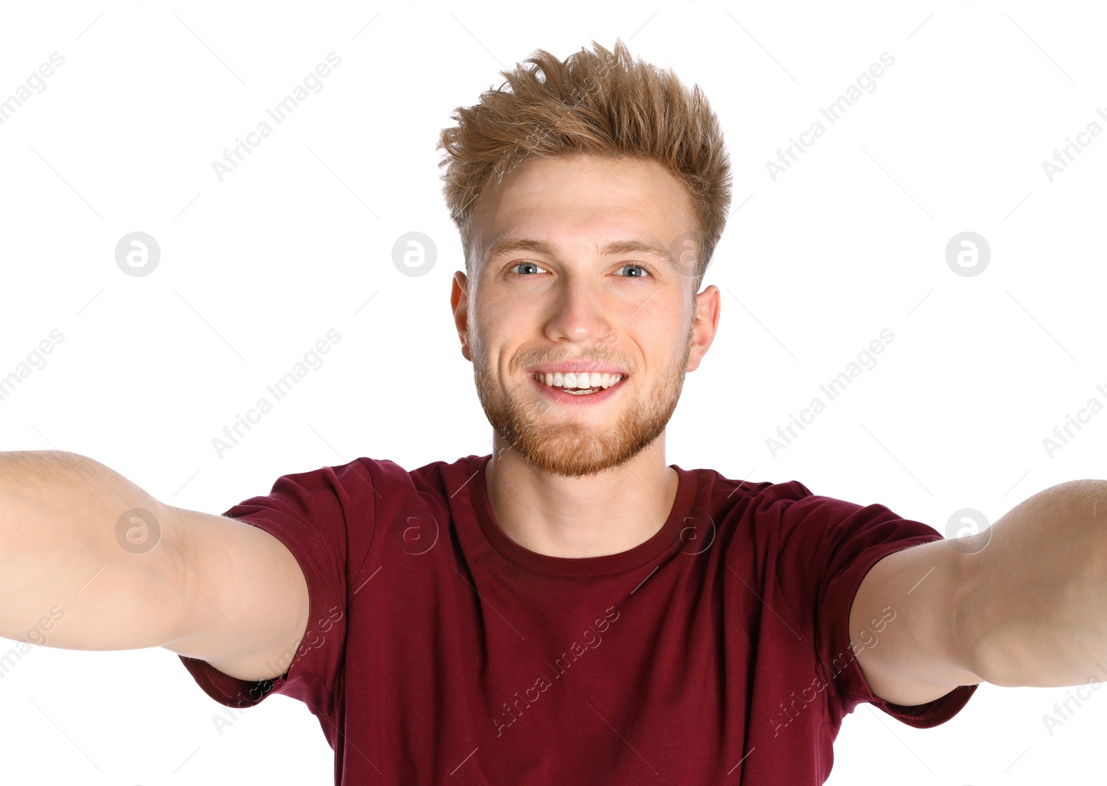 Photo of Happy young man taking selfie on white background