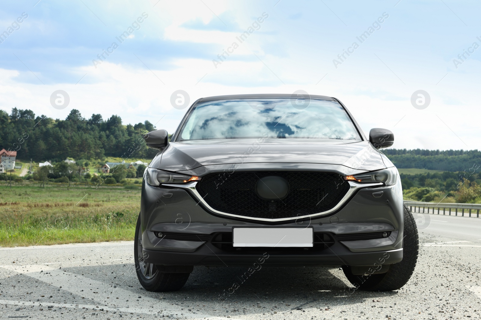 Photo of New black modern car on asphalt road