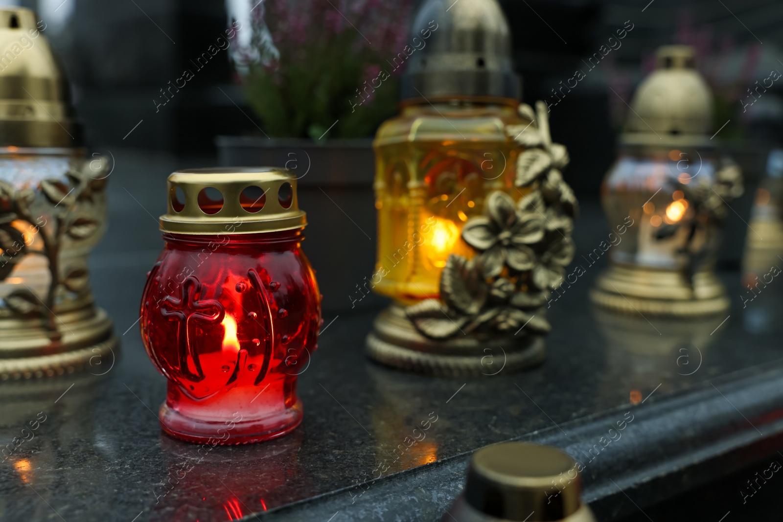 Photo of Grave lights on granite surface at cemetery