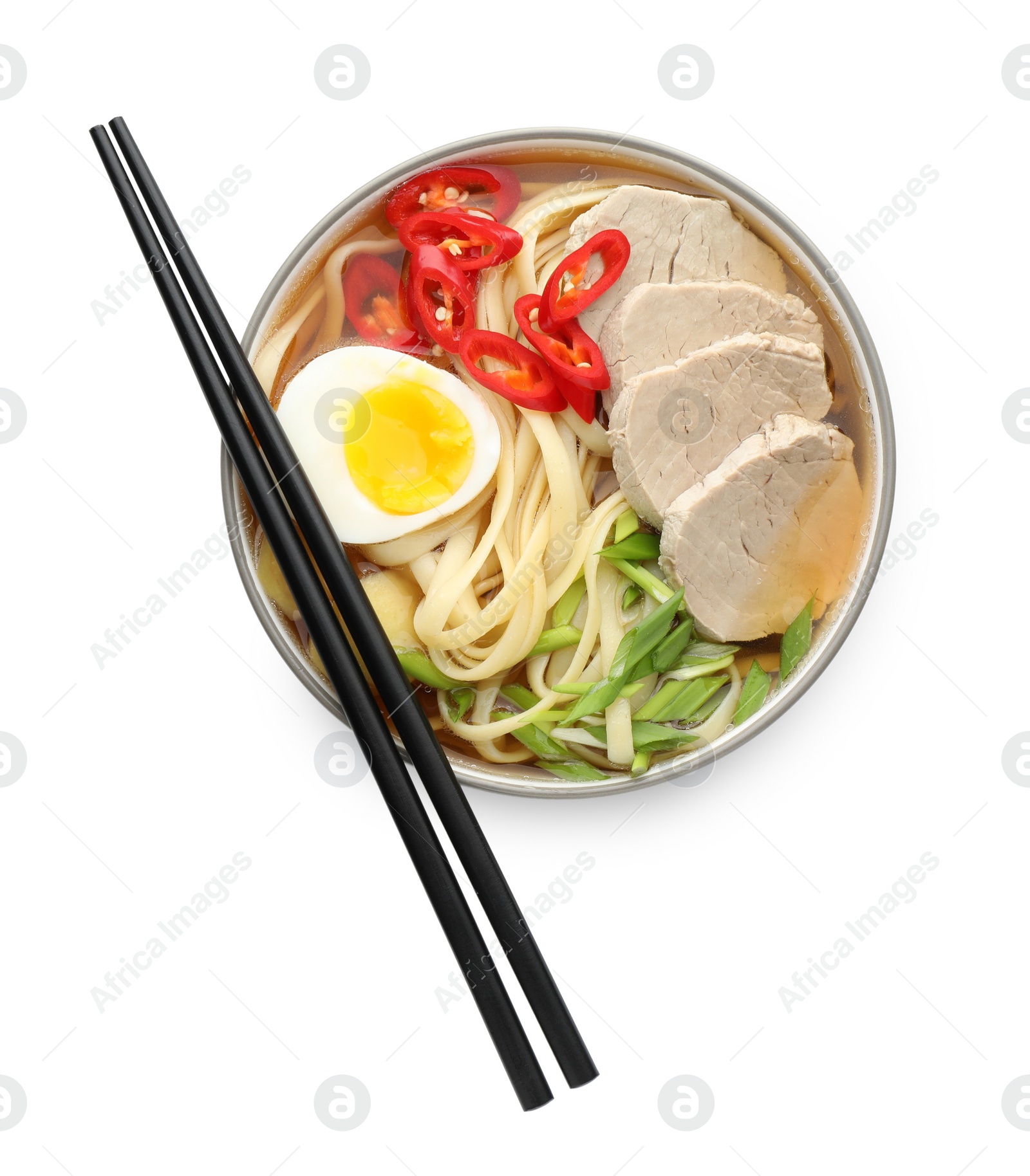 Photo of Delicious ramen in bowl and chopsticks isolated on white, top view. Noodle soup