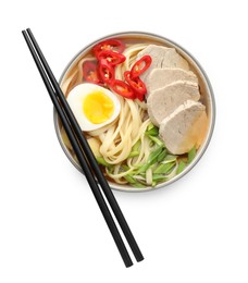 Photo of Delicious ramen in bowl and chopsticks isolated on white, top view. Noodle soup