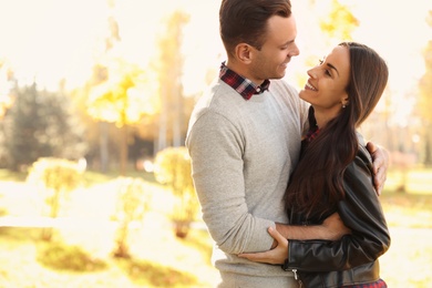 Photo of Happy couple in sunny park. Autumn walk