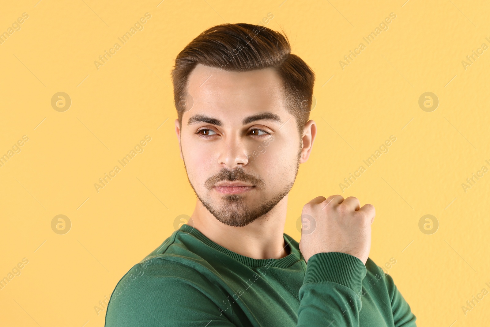 Photo of Portrait of young man with beautiful hair on color background