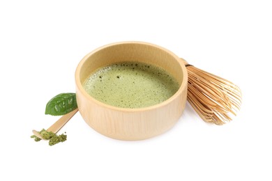 Cup of fresh green matcha tea, bamboo whisk and spoon isolated on white