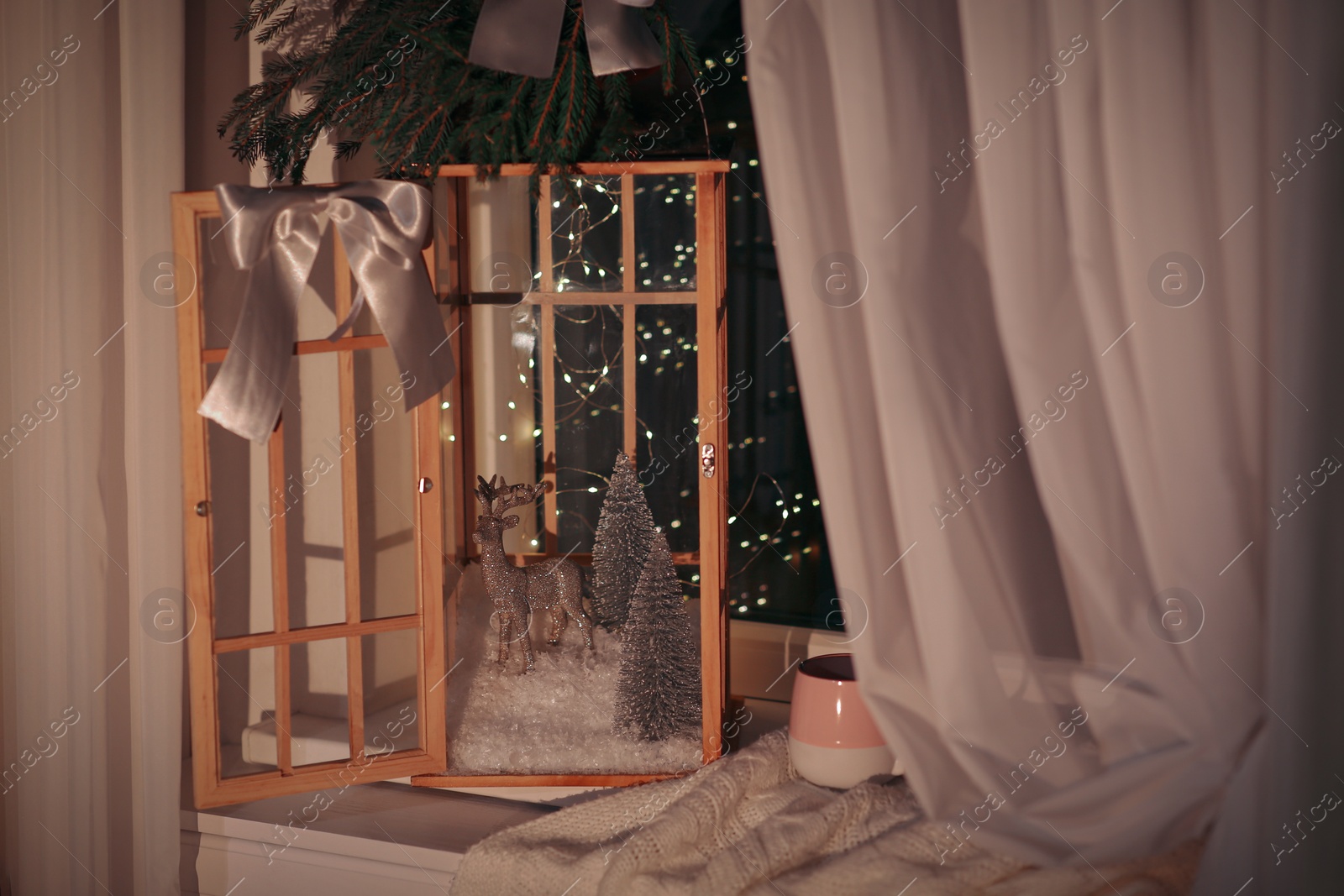 Photo of Vintage wooden lantern with beautiful Christmas composition on window sill indoors
