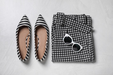 Photo of Stylish women's shoes, clothes and sunglasses on grey background, flat lay