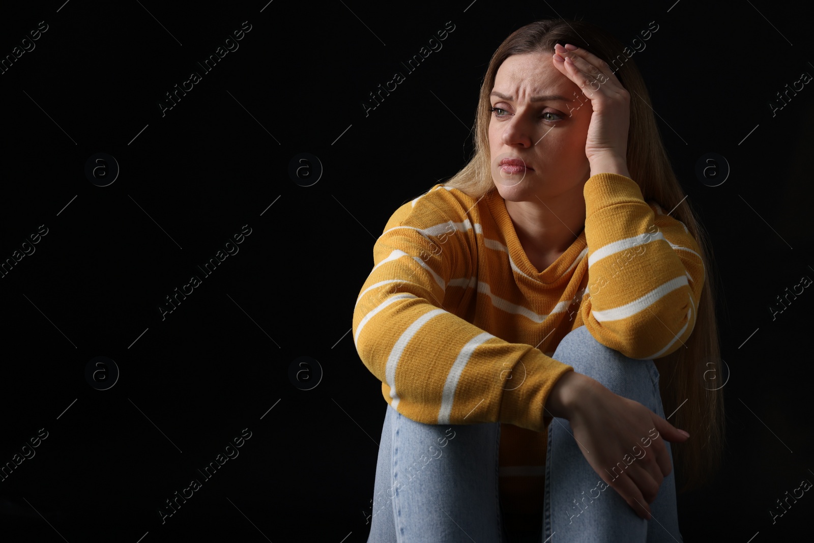 Photo of Portrait of sad woman on black background, space for text