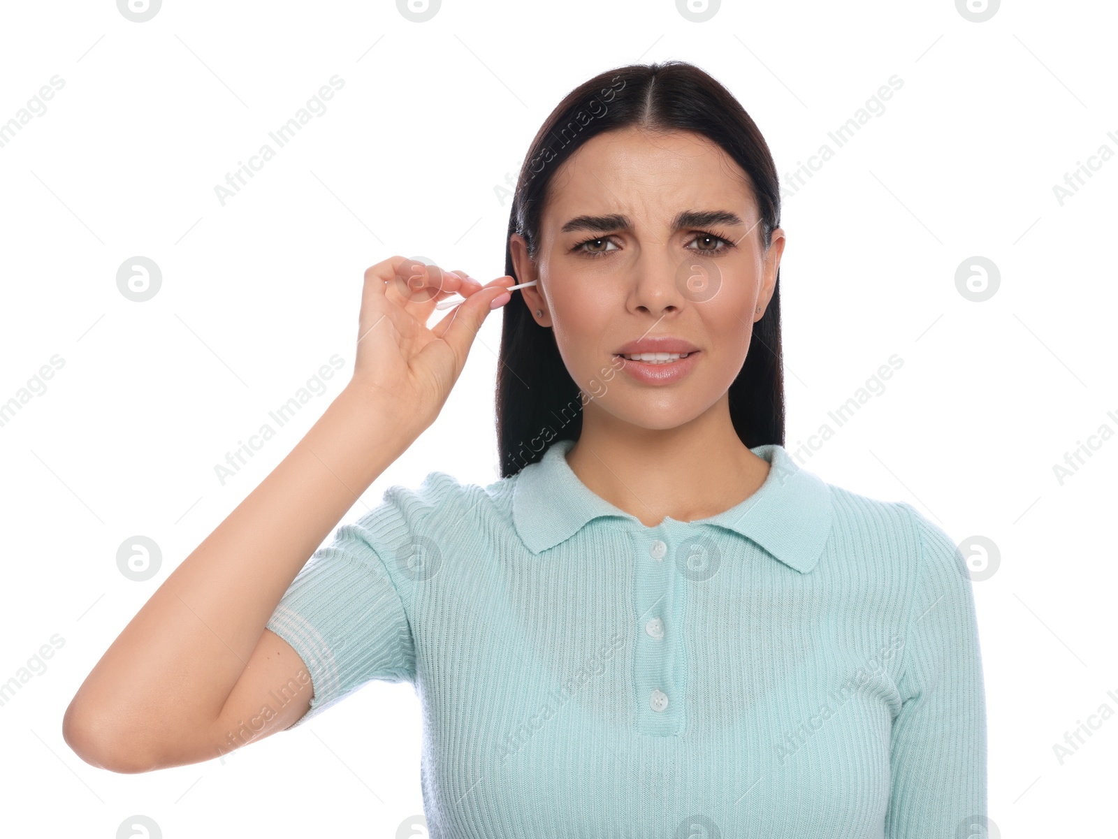 Photo of Young woman cleaning ear with cotton swab on white background