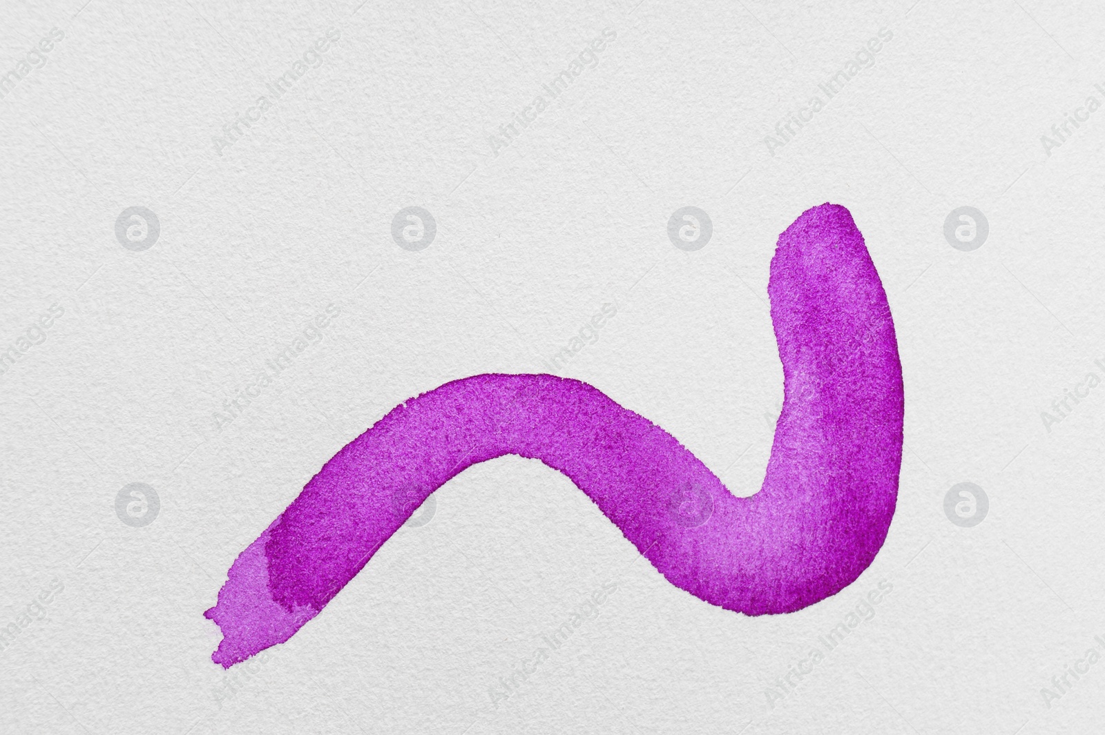 Photo of Stroke of purple watercolor paint on white background, top view