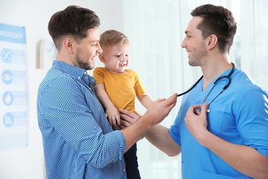 Photo of Father with child visiting doctor in hospital