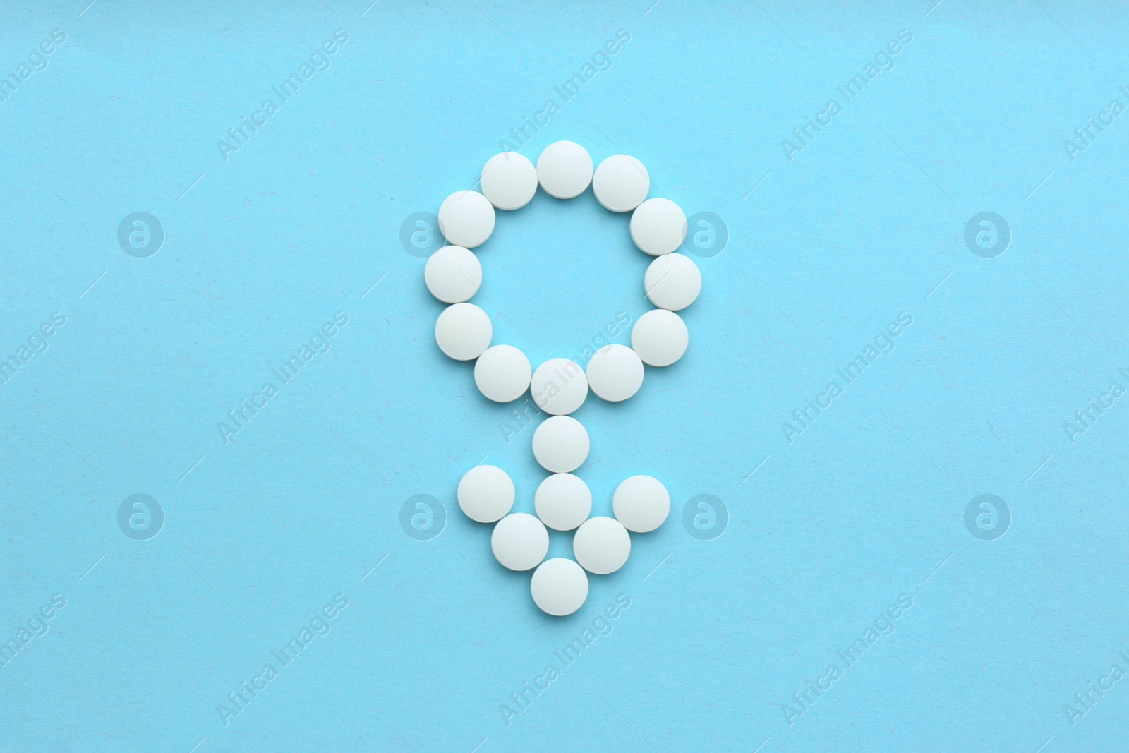 Photo of Male sign made of white pills on light blue background, flat lay. Potency problems