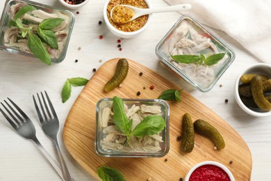 Delicious aspic and ingredients served on white wooden table, flat lay