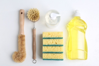 Photo of Flat lay composition with cleaning supplies for dish washing on white background