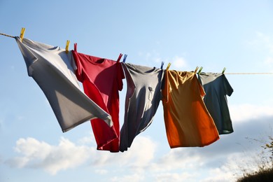 Photo of Clothes hanging on washing line against sky