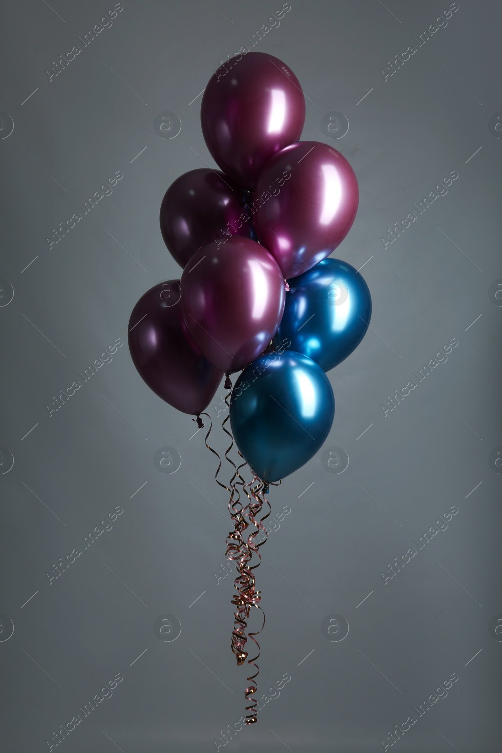 Photo of Bunch of color balloons on grey background