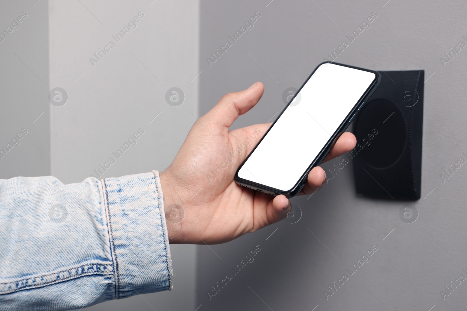 Photo of Man unlocking door using smartphone, closeup view