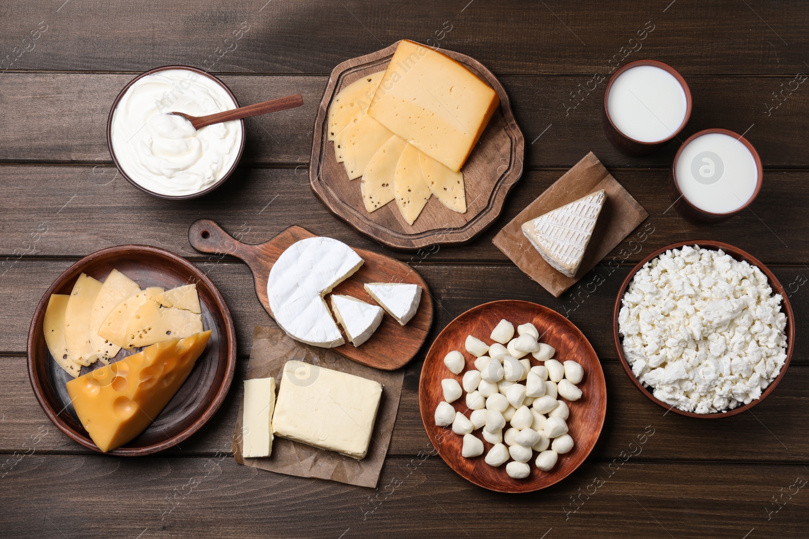 Photo of Flat lay composition with dairy products on wooden table