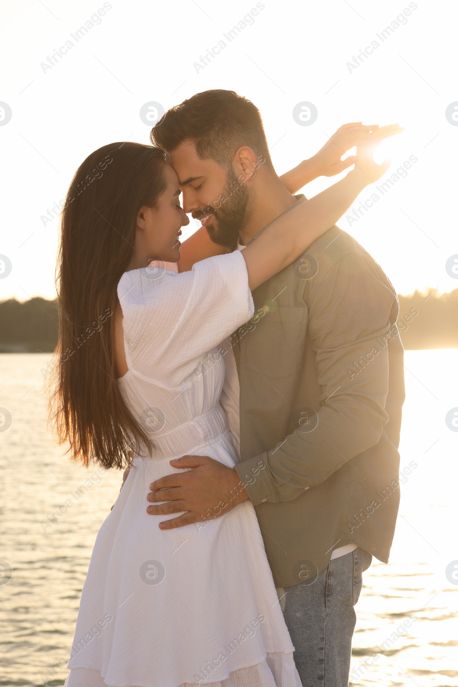 Photo of Beautiful couple dancing near river on sunny day