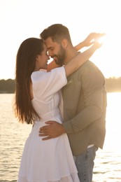 Photo of Beautiful couple dancing near river on sunny day
