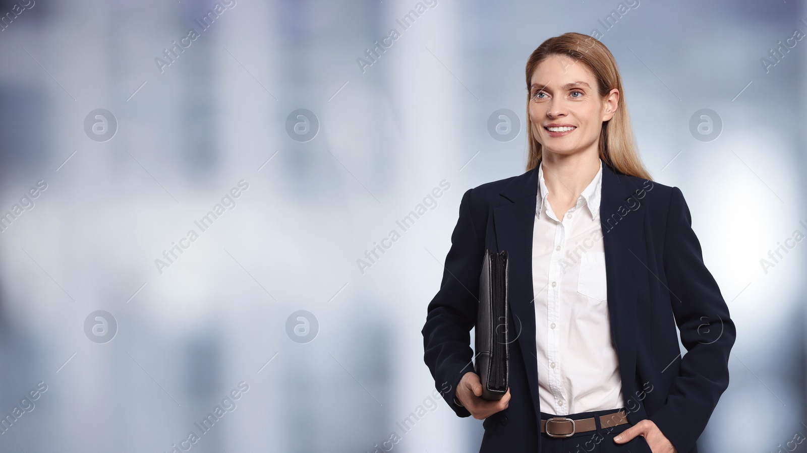Image of Beautiful real estate agent with portfolio in office, space for text