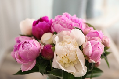 Photo of Bouquet of beautiful peonies on blurred background, closeup