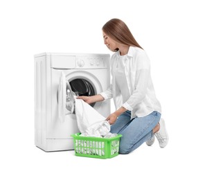 Photo of Beautiful young woman taking laundry out of washing machine on white background
