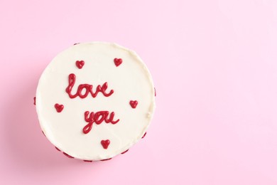 Photo of Bento cake with text Love You and space for text on pink table, top view. St. Valentine's day surprise