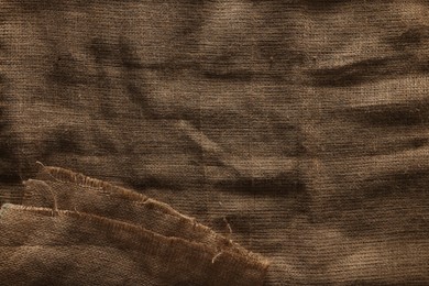 Photo of Texture of natural burlap fabric as background, top view