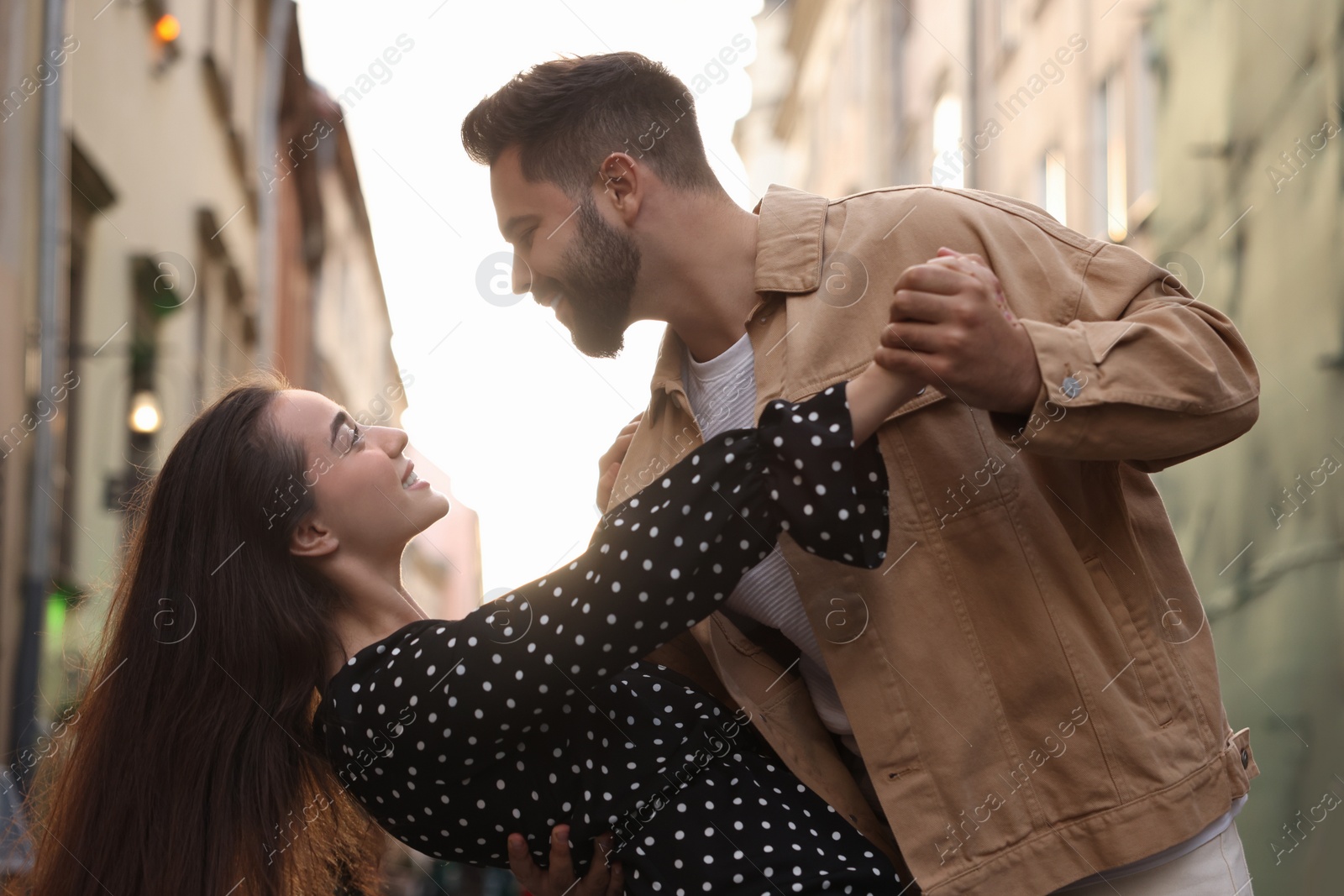 Photo of Lovely couple dancing together on city street