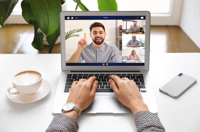 Image of Woman having video chat with team at table, closeup