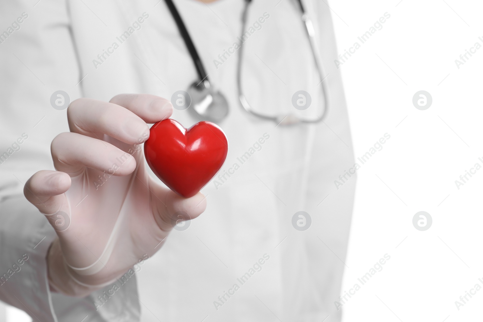 Photo of Doctor in medical glove holding red heart on white background, selective focus