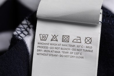 Photo of Clothing label on striped garment, closeup view