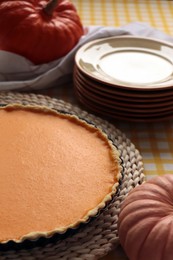 Photo of Delicious homemade pumpkin pie in baking dish on table