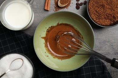 Photo of Whipping cream for dalgona coffee at gray table, top flat lay