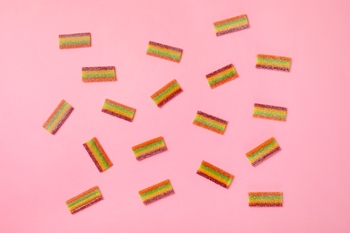 Photo of Flat lay composition with yummy candies on color background