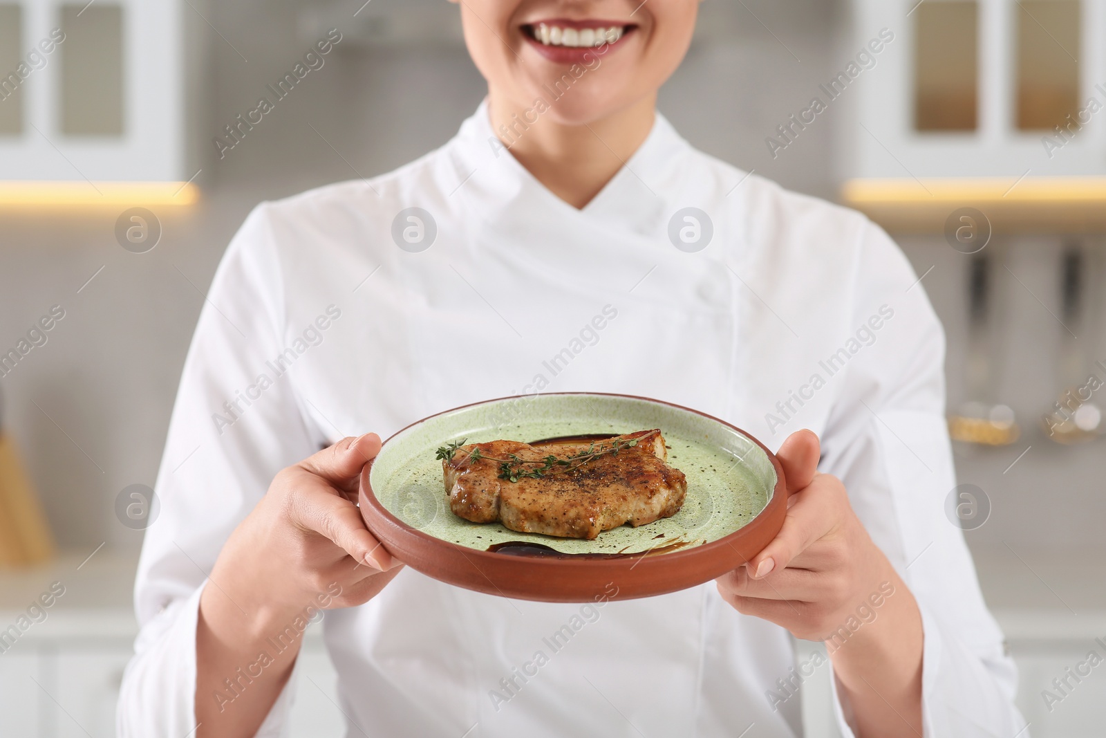 Photo of Closeup of professional chef presenting delicious meat in kitchen, focus on food